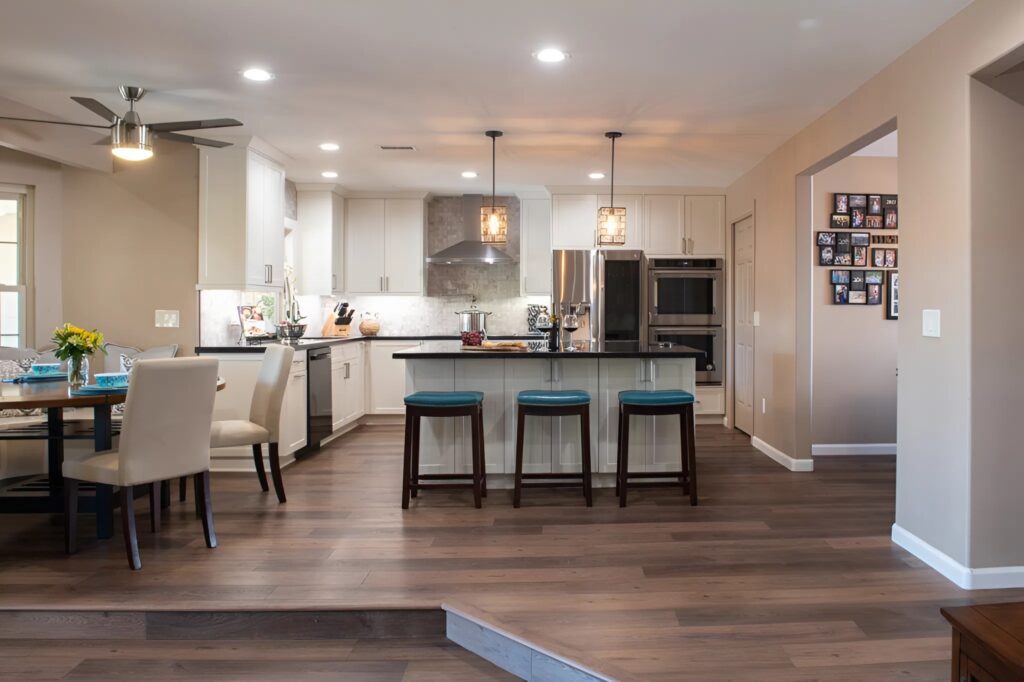 Kitchen and dining area with warm beige wall paint and crisp white cabinetry by an interior painter in Worthington, OH