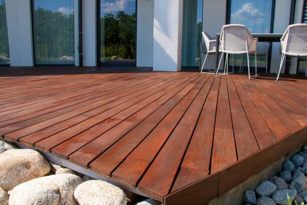 Freshly stained natural wood deck outside a modern home, showcasing a durable finish by a painting company in Worthington, OH.