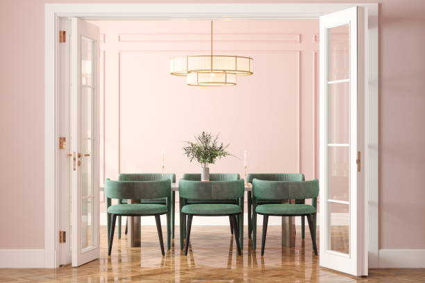 Dining room with soft blush pink painted walls and crisp white trim by an interior painter in Lewis Center, OH.
