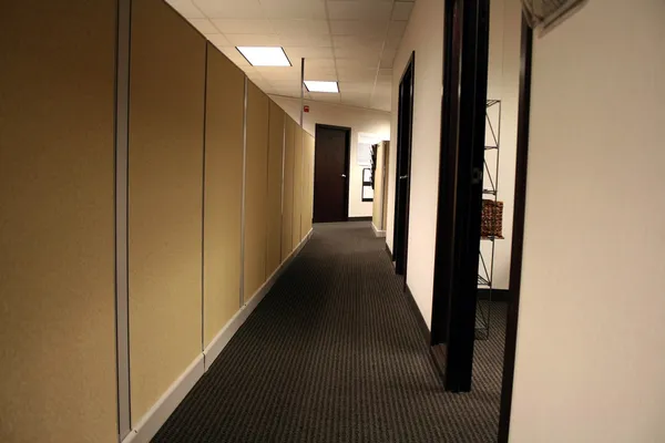 Office hallway with warm beige walls and neutral paint finishes by a painting company in Gahanna, OH.